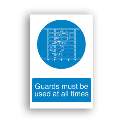 Guards Must Be Used at All Times mandatory sign safety sign with a white line drawing of a machine guard — a rectangular grid-panel with triangular teeth along the bottom edge — shown secured in place over a hazardous area, set within a blue mandatory circular background.