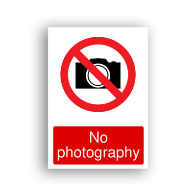 No Photography prohibition sign safety sign with black silhouette of a camera enclosed within a red prohibition circle with a diagonal red bar running from upper left to lower right.