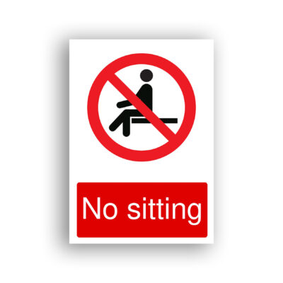 No Sitting prohibition sign safety sign with black pictogram of a person seated on a surface, enclosed within a red prohibition circle with a diagonal red bar across it.